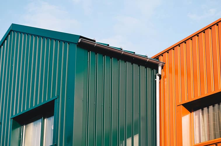 Painted exterior aluminum siding painted in green and orange