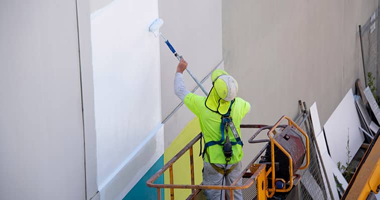 worker painting in lift